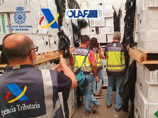 Spanish police officers looking at seized boxes of refrigerant gases