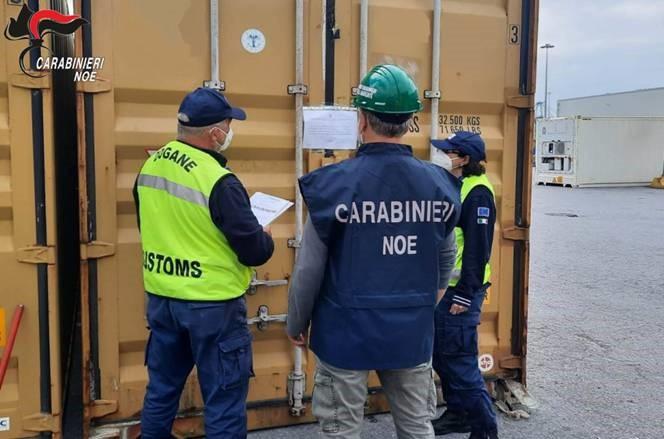 Customs officers looking at a container