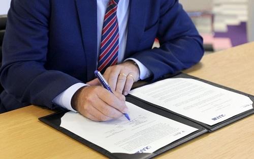 Man signing official document