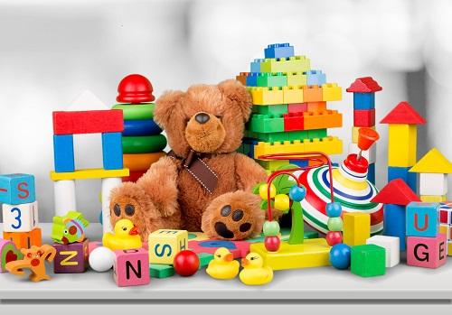Different toys such as a teddy bear and building blocks