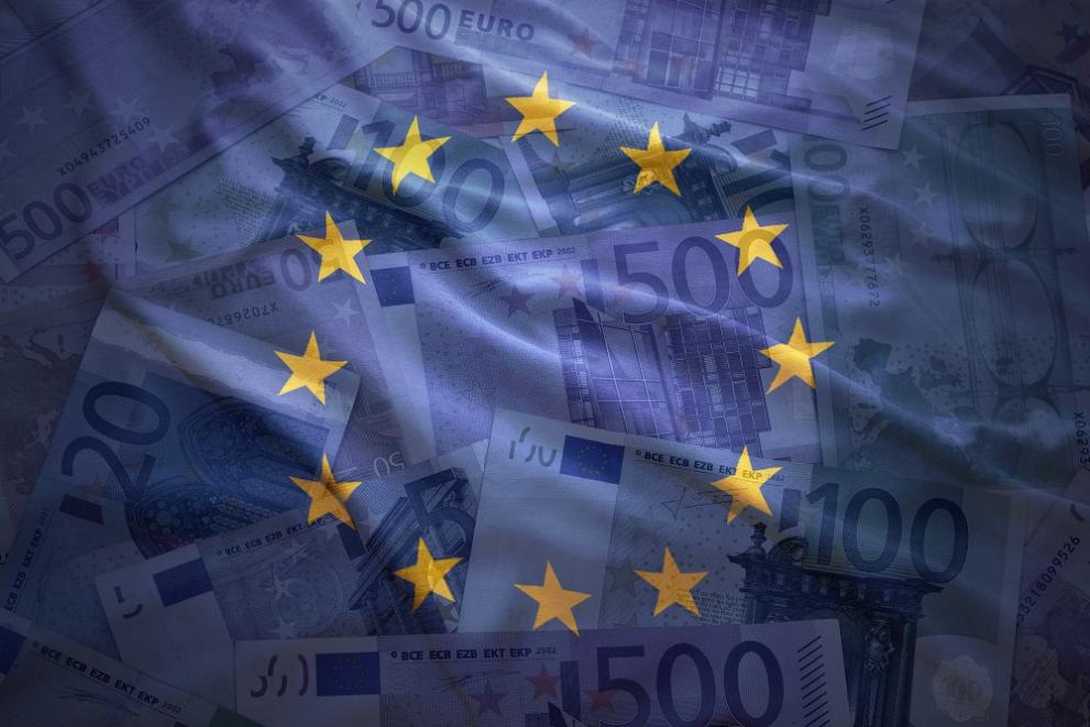 EU flag on a background of euro notes