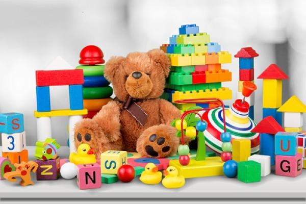 Different toys such as a teddy bear and building blocks