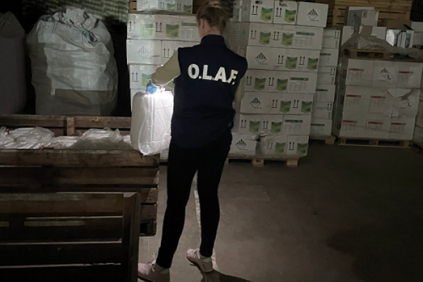 OLAF investigator looking at bags an boxes of pesticides
